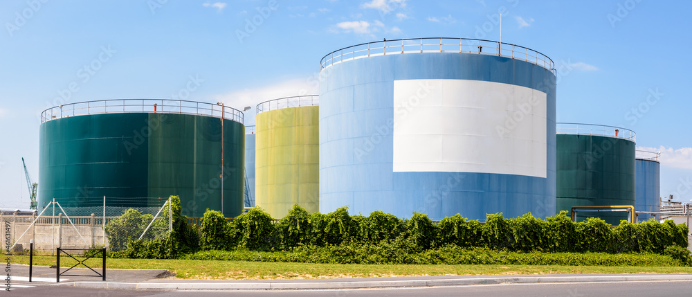 Wall mural storage tanks in an oil terminal with a white blank copy space