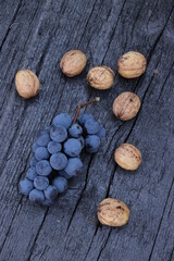 bunch of grapes on wooden background, place for text 