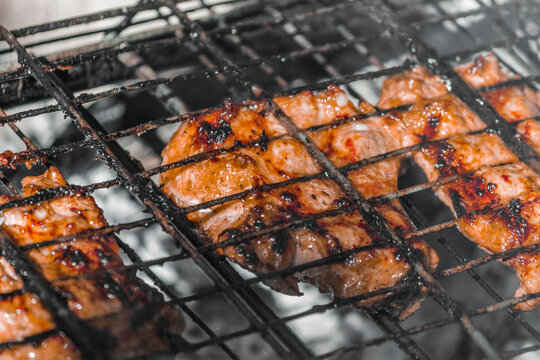 Fried ruddy chicken meat on a manal on the street. Street food. Chicken kebab in nature. High quality photo