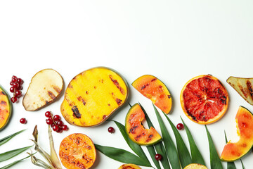 Concept of tasty food with grilled fruits on white background.