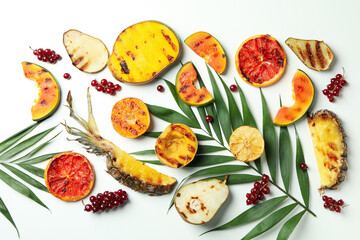 Concept of tasty food with grilled fruits on white background.