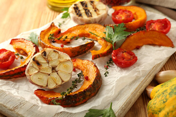 Concept of cooking with baked pumpkin on wooden background