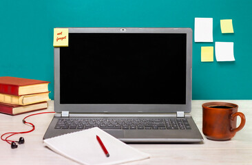 laptop, notepad and coffee mug on the desk. Learning concept