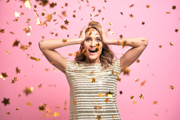Blonde woman have fun with gold confetti