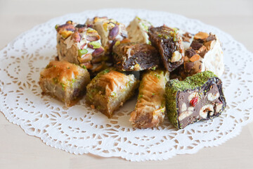 traditional Turkish sweets, baklava, lies on a beautiful napkin on the table. Treats, delicacies, nuts, nougat. Turkish sweets