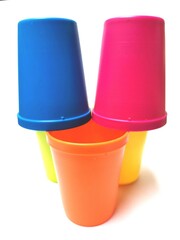 Front view of randomly stacked colorful plastic cups