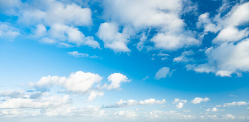 Stunning view of a blue sky with some fluffy clouds during a sunny day. Natural background, sky replacement, copy space..