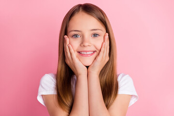 Photo of cute blond small girl hands face wear white t-shirt isolated on pink color background