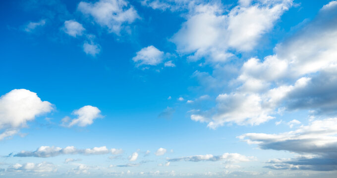 Stunning view of a blue sky with some fluffy clouds during a sunny day. Natural background, sky replacement, copy space..
