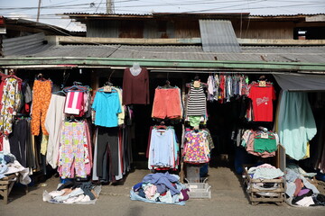 colorful clothes hanged and displayed in front of the shop in the market of iligan city, mindanao island