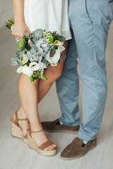 Obraz na płótnie Canvas closeup shot of newlyweds hands with wedding bouquet
