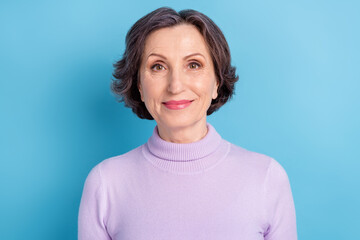 Photo of aged attractive woman happy positive smile wear lilac color pullover isolated over blue color background