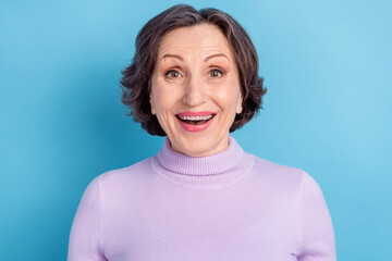 Photo of aged woman happy positive smile excited amazed news sale isolated over blue color...