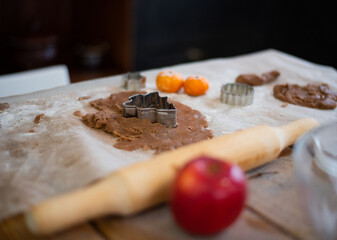 The process of making New Year's ginger cookies, dough, flour, tangerines, close up on the table.