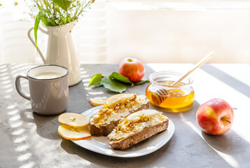 Bread slices with cottage cheese, honey, apples and nuts. Breakfast concept