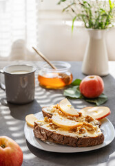 Bread slices with cottage cheese, honey, apples and nuts. Breakfast concept