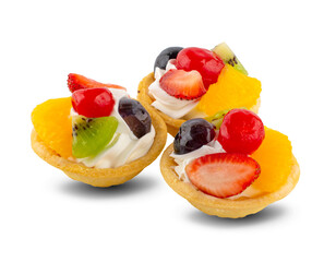 fruit and berry tart dessert with toss sugar on wooden background. Fresh delicious sweet cake with raspberries, grapes, strawberries, cherry, kiwi, grapefruit and cream.