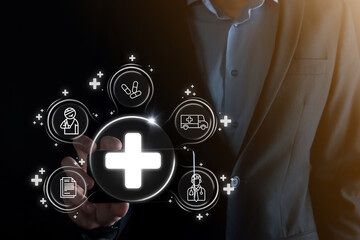 Businessman hold virtual plus medical network connection icons. Covid-19 pandemic develop people awareness and spread attention on their healthcare.Doctor,document,medicine,ambulance,patient icon.