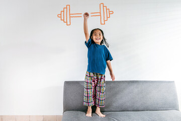 A strong Asian little toddler kid girl lifting drawing weight against the white background. For...
