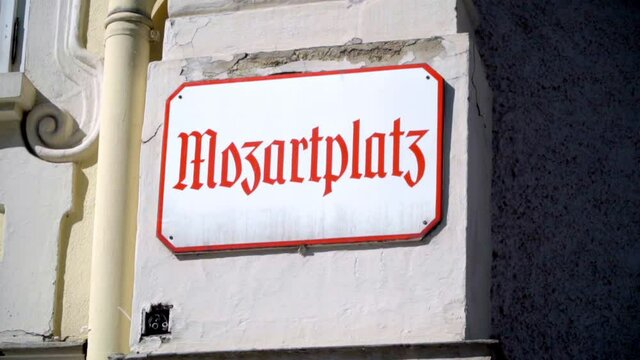 front statuette where we can see the Scriptures that say that  Mozartplazt in Salzburg Austria
