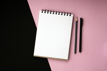 Planner layout, open blank spiral notebook for design, lettering, text, template. Pink background, pen, pencil.
