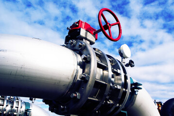 Industrial zone, Steel pipelines and valves against blue sky