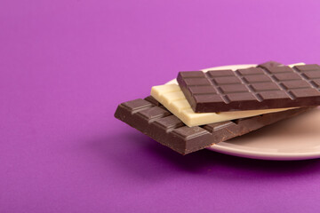 Chocolate with plate on purple table