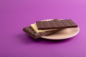 Chocolate with plate on purple table