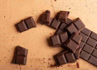 Chocolate with plate on brown rustic background