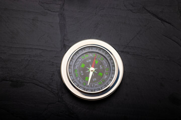 Navigation compass on black slate background