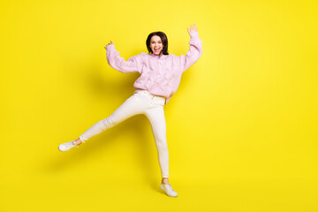 Full size photo of funny millennial lady dance wear sweater pants isolated on yellow color background