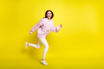Fototapeta na wymiar Full length profile photo of funky millennial lady go wear sweater pants isolated on yellow color background
