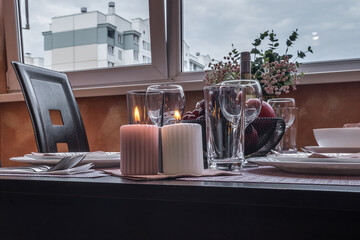  Interior of  kitchen in studio apartments with a served table with wine, fruit and candles