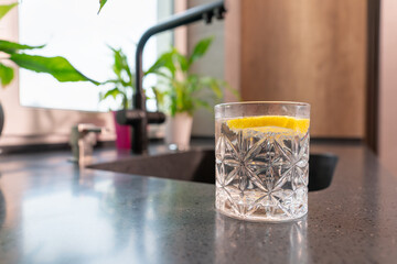 Glass of refreshing water with slice of tangy lemon