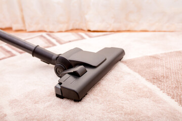 Vacuum cleaner in the room on the carpet, cleanliness in the house, cleaning