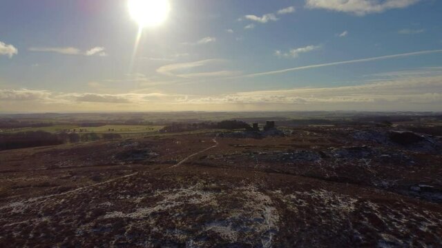 Sun-drenched flyover Rothley Castle, Northumberland. Dolly Shot.