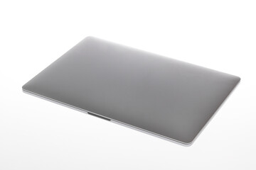 Isolated closeup studio shot of close cover silver metallic wifi wireless digital laptop notebook computer mockup working technology device for text copy space advertisement on white background - Powered by Adobe