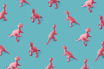 Keuken spatwand met foto Creative isometric pink painted dinosaur toy pattern on blue background.  Minimal abstract concept for school and kids. © Santijago