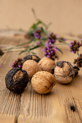 Walnuts on wooden table with flower