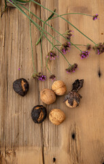 Walnuts on wooden table with flower