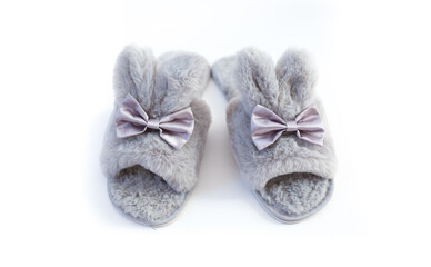 Slippers in the shape of a bunny with ears isolated on a white background, women's or children's indoor clothing, cute fluffy fur slippers home