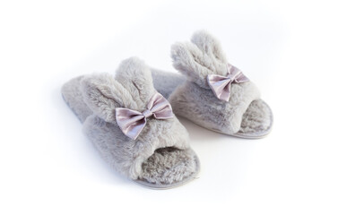 Slippers in the shape of a bunny with ears isolated on a white background, women's or children's indoor clothing, cute fluffy fur slippers home
