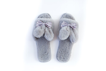 Slippers in the shape of a bunny with ears isolated on a white background, women's or children's indoor clothing, cute fluffy fur slippers home