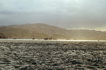 Istanbul. fisherman fishes on Bosporus Istanbul on a Foggy sunrise. Rainy clouds and dark weather