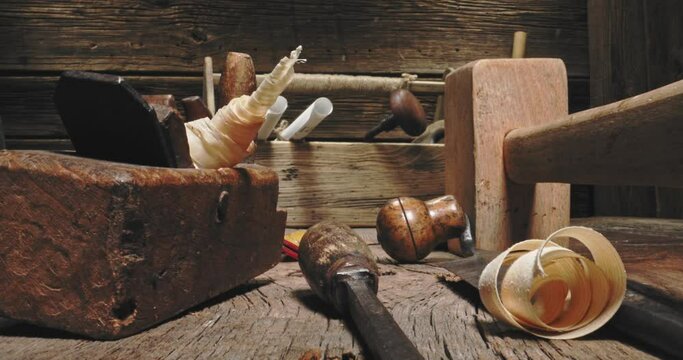 Old joinery workbench. Planes, tampers and chisels in carpentry workshop.