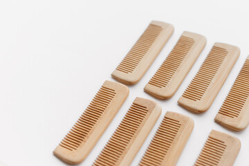 wooden combs scattered isolated on white background, flat lay, top view