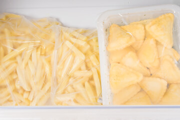 frozen semi-finished products from french fries and dough are in the freezer drawer