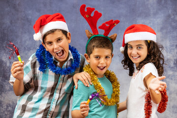 Three funny kids celebrating Christmas
