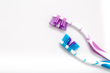 Toothbrushes on a white background. Oral hygiene. Male and female couple, family hygiene and relationships.