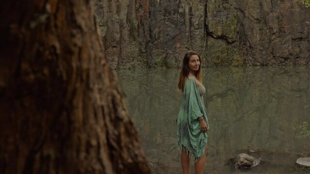 Girl With Scarf Behind Tree Trunks - Cedar Creek Falls In QLD, Australia. Dolly Shot